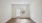 a room with a wood floor and a window with blinds