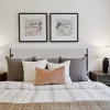 a bedroom with a bed and two nightstands