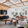 a clubhouse room with a couch, tables and chairs